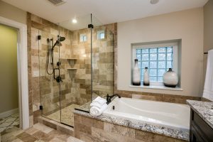 Master Bathroom with standing glass shower and a tub